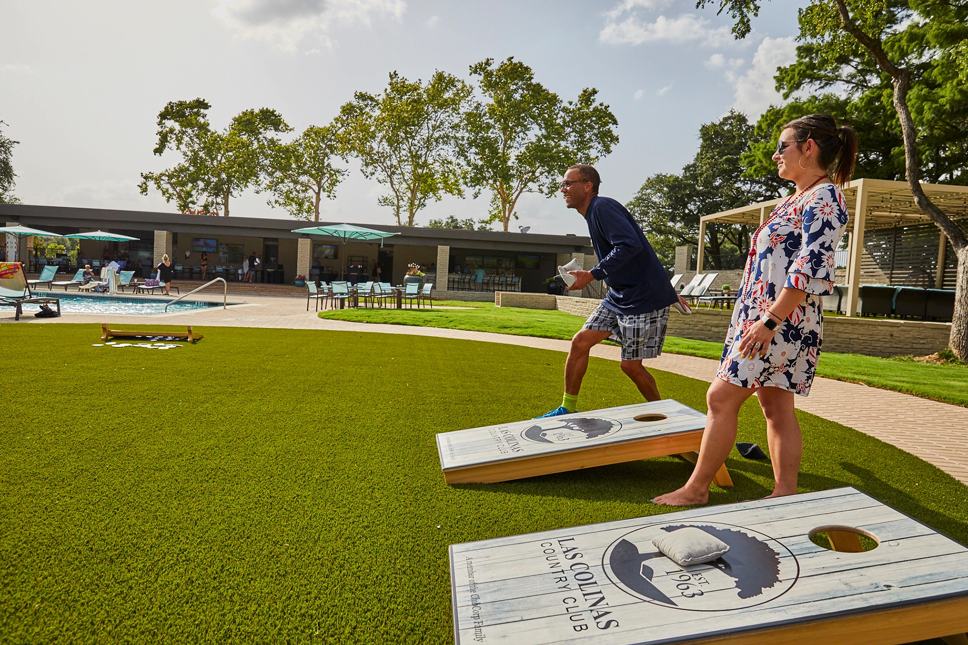 Las Colinas Country Club - Members enjoying games around  pool