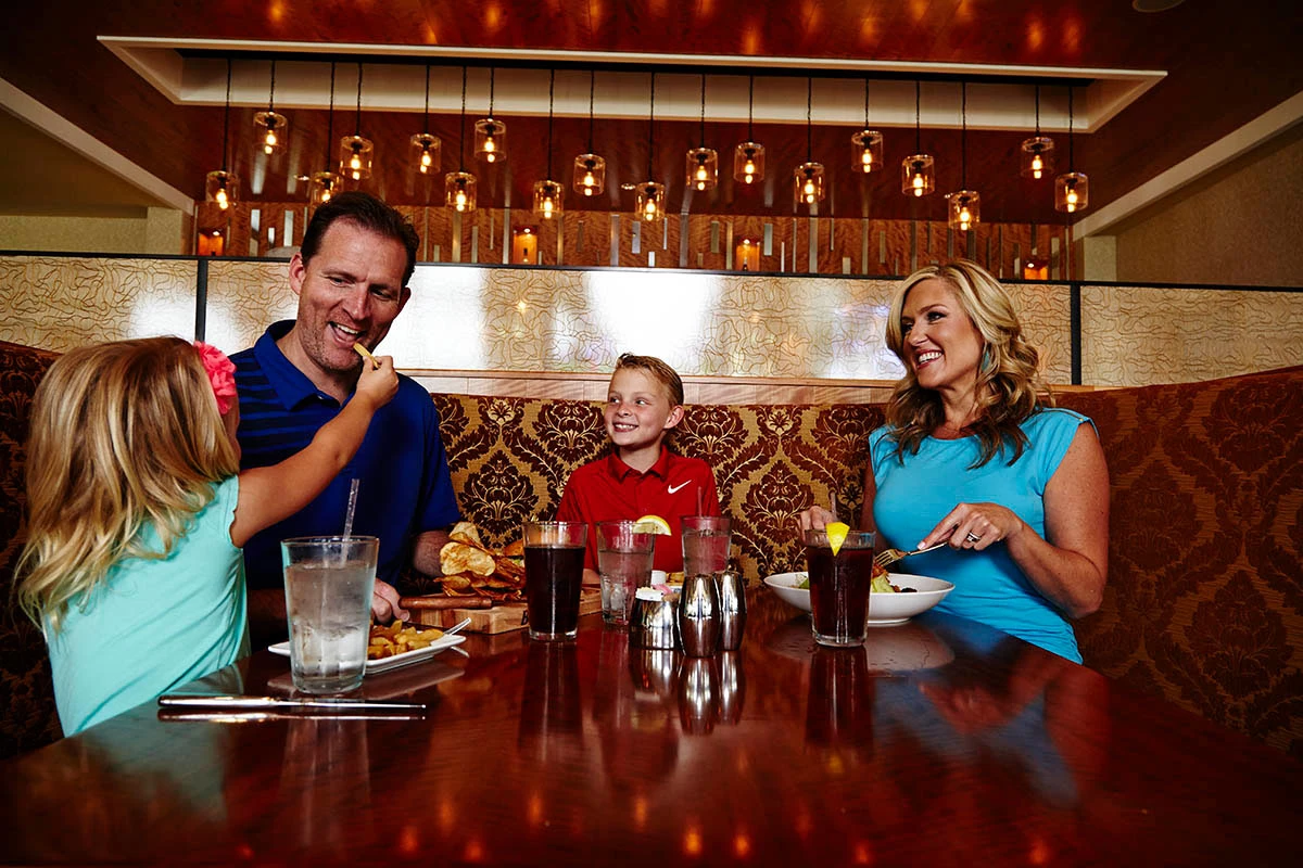 family enjoying food at Mitchells Chophouse